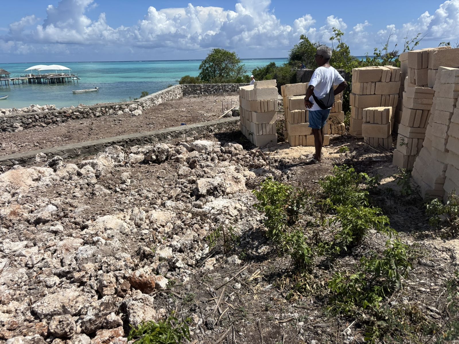 Stacks of island stone on the plot at the start of construction
