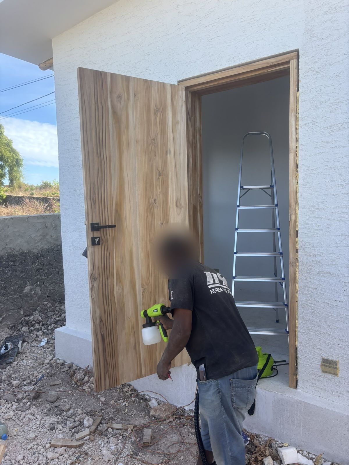 A teak door being finished on site