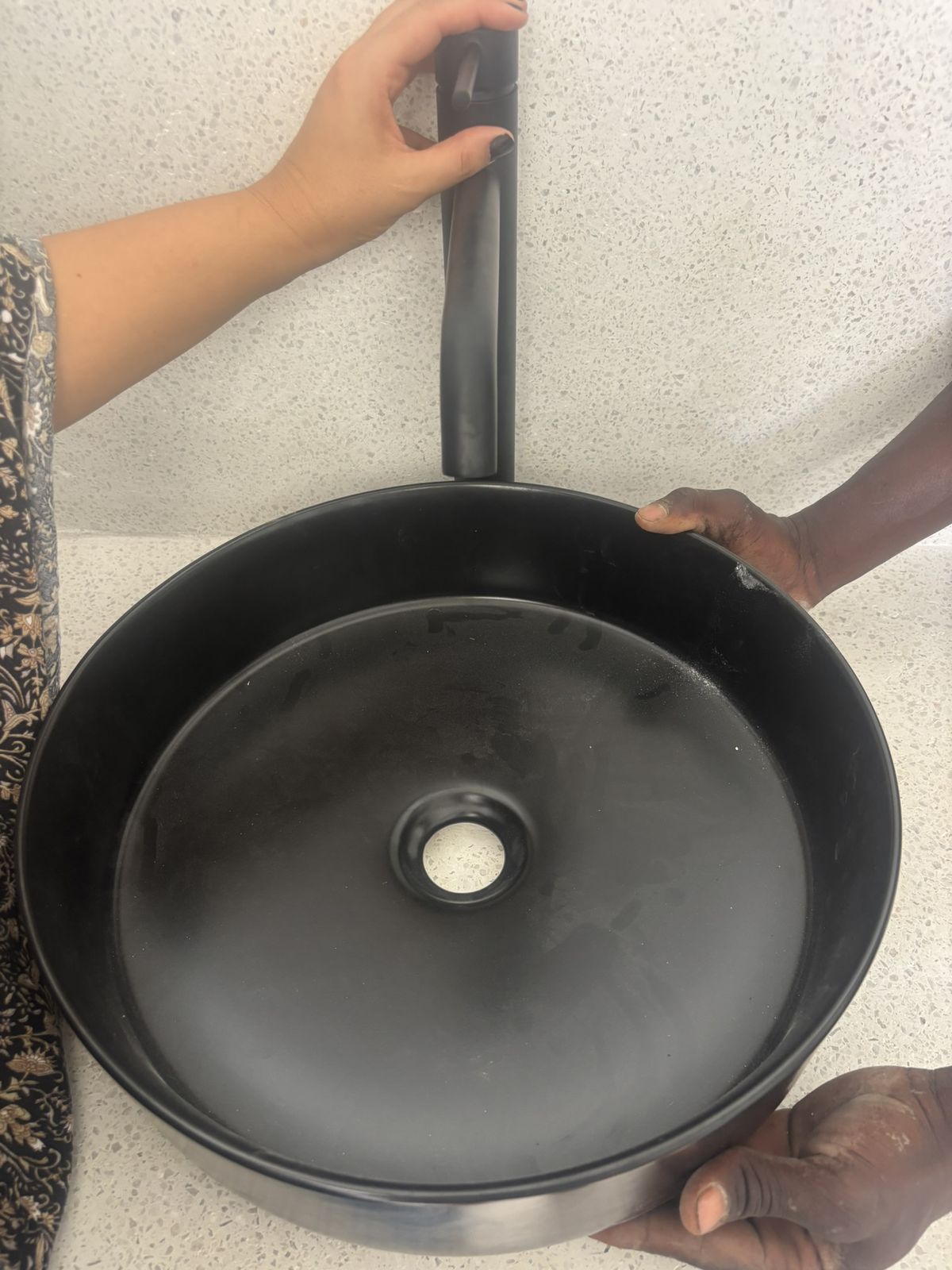 A basin being fitted in one of the bathrooms