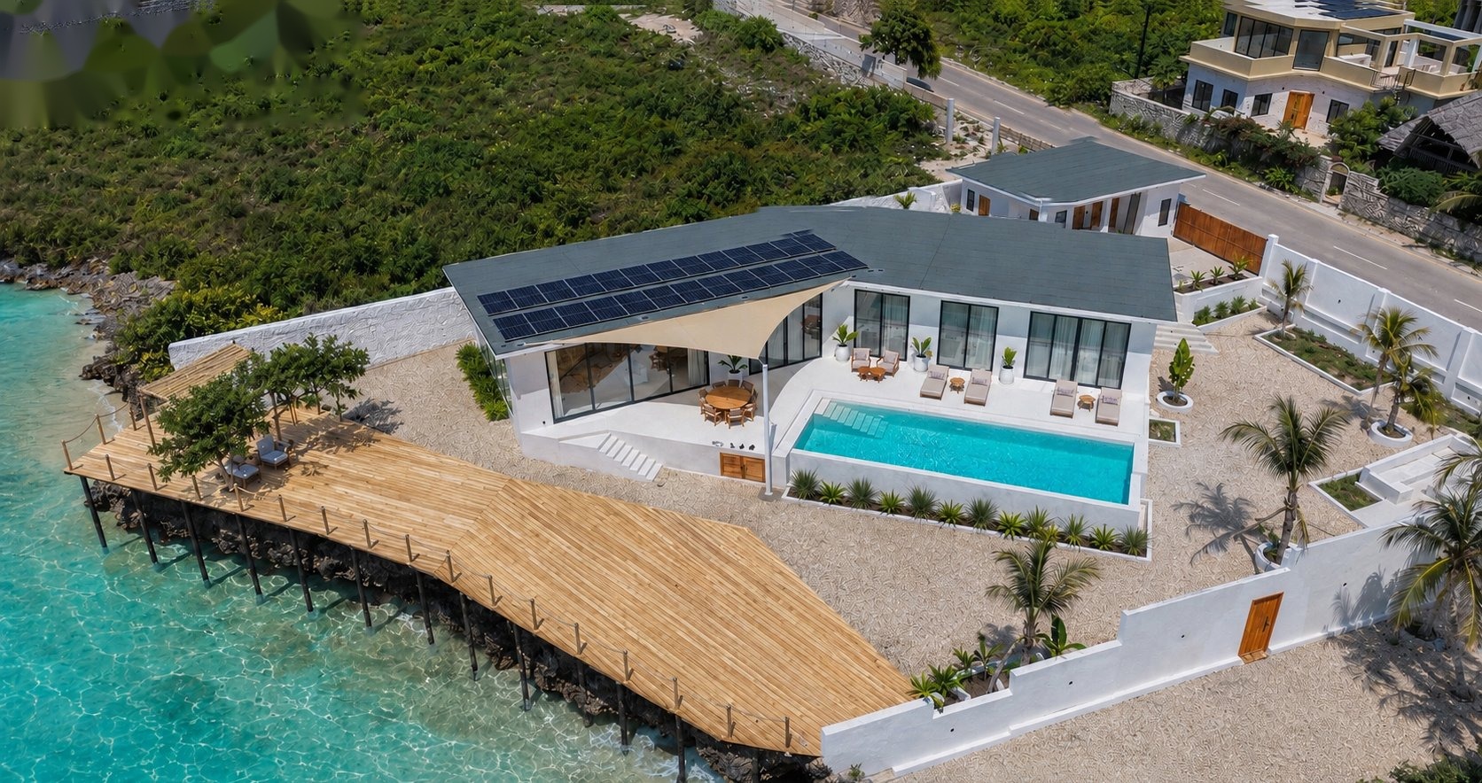 Aerial view of Zuri Cliff villa and timber deck over the ocean