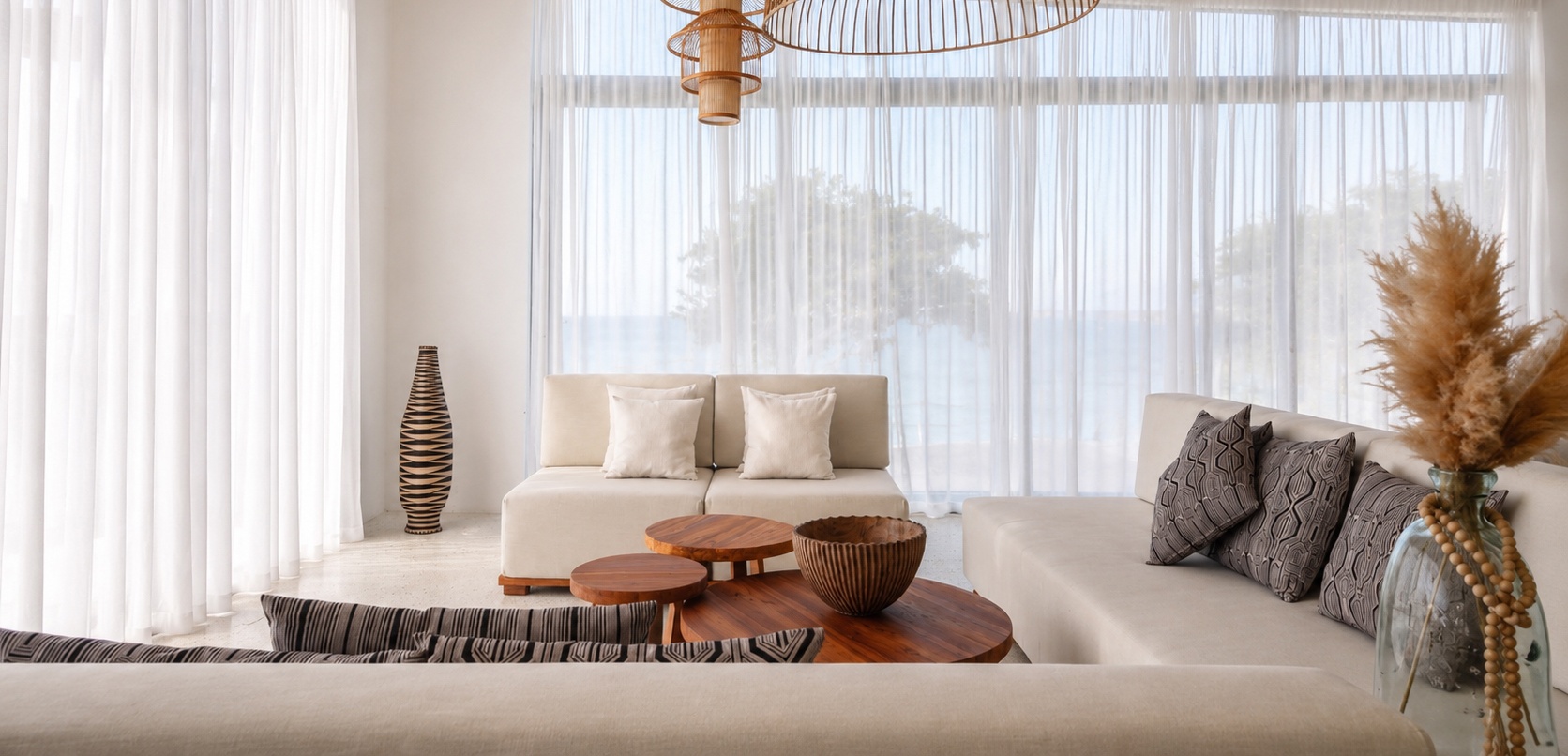 Living room lounge with sheer curtains and ocean view at Zuri Cliff villa